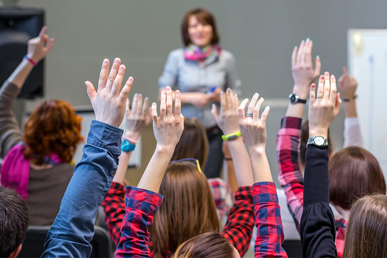 A group of people around each other
Description automatically generated